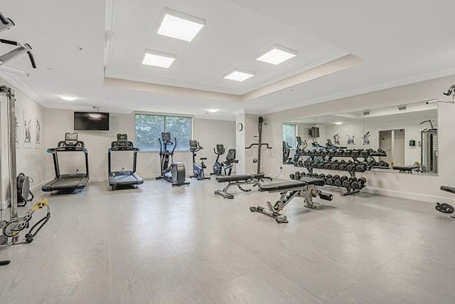 exercise room featuring a tray ceiling and crown molding