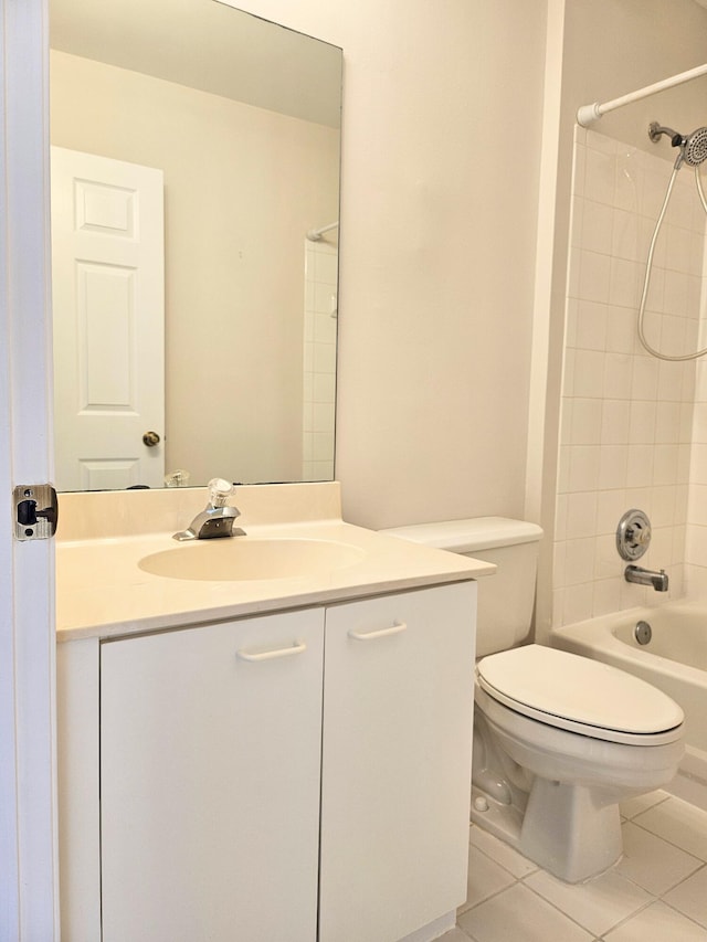 full bathroom featuring tile patterned flooring, vanity, toilet, and tiled shower / bath