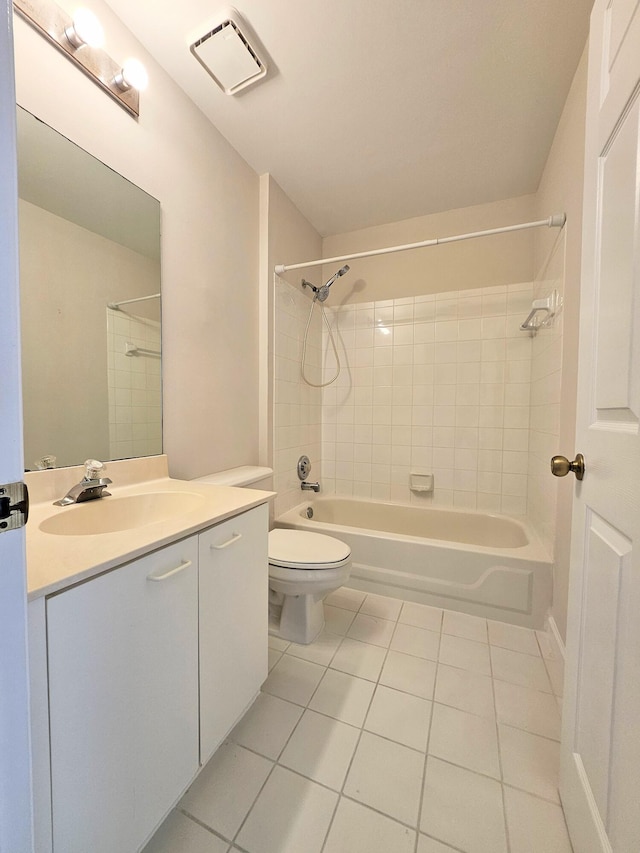 full bathroom with tile patterned floors, tiled shower / bath combo, toilet, and vanity