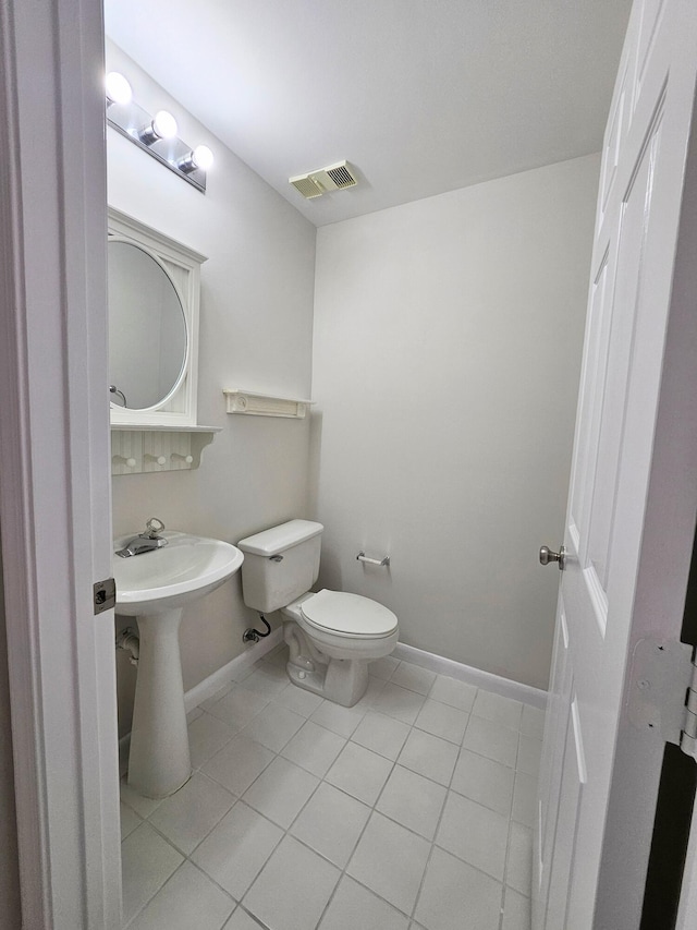 bathroom with toilet and tile patterned floors