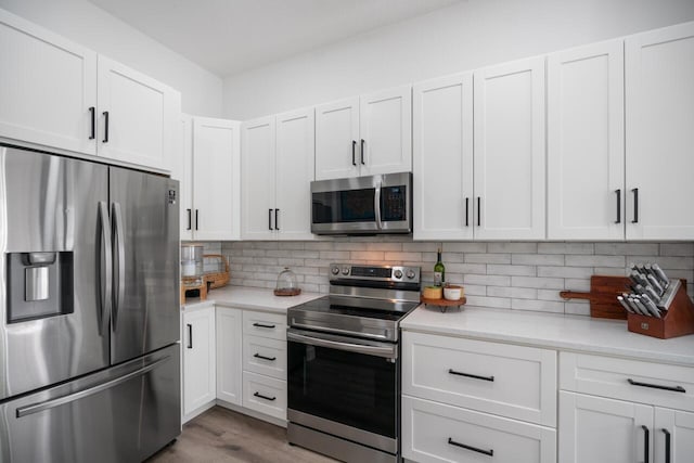 kitchen featuring white cabinetry and appliances with stainless steel finishes