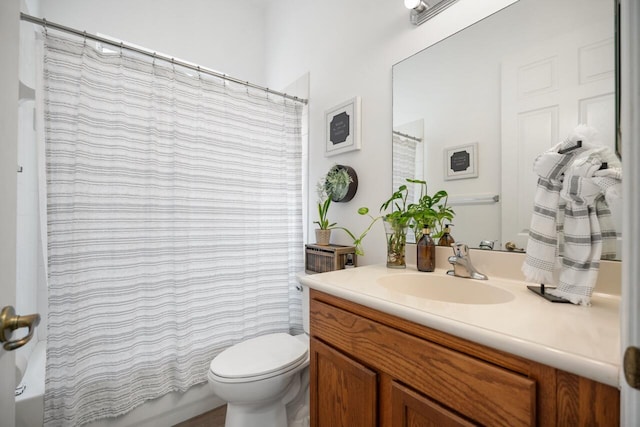 full bathroom with vanity, shower / tub combo, and toilet