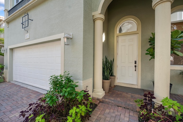 doorway to property with a garage