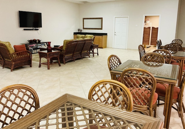 dining space featuring light tile patterned floors