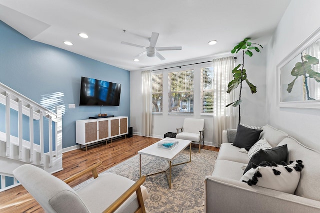 living room with wood-type flooring and ceiling fan