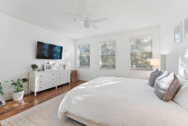 bedroom featuring dark hardwood / wood-style flooring and ceiling fan