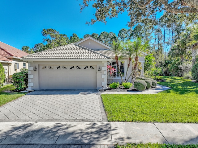 view of front facade with a garage and a front yard