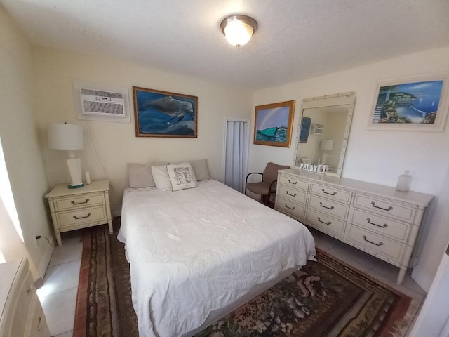 bedroom with dark hardwood / wood-style flooring and a wall mounted air conditioner