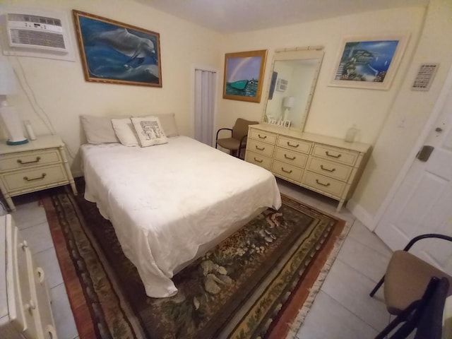 bedroom with light tile patterned flooring and a wall mounted air conditioner