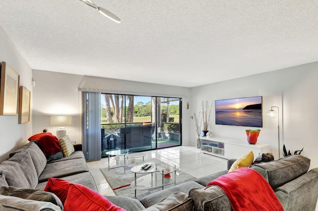 living room featuring light tile patterned flooring and a textured ceiling