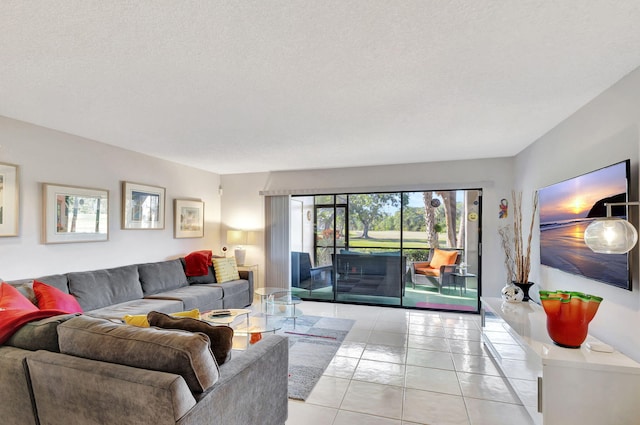 living room with a textured ceiling and light tile patterned flooring