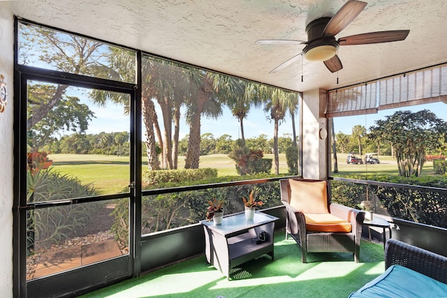 sunroom / solarium featuring ceiling fan