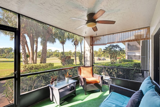 sunroom featuring ceiling fan