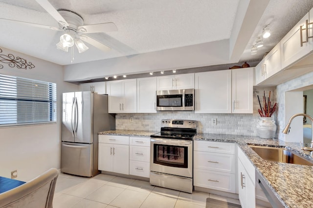 kitchen featuring white cabinets, decorative backsplash, sink, and appliances with stainless steel finishes