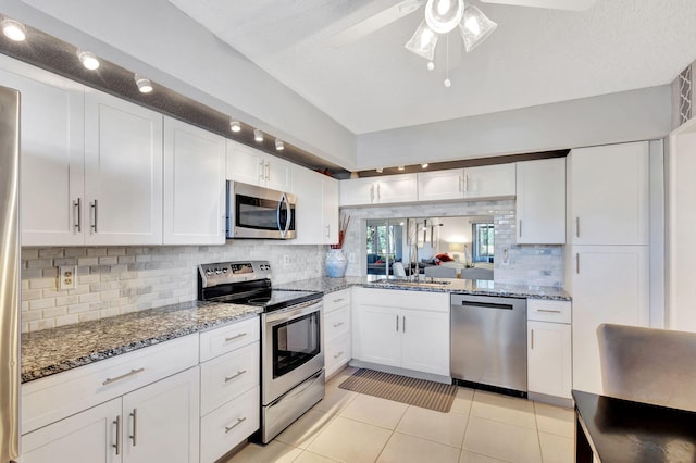 kitchen featuring white cabinets, appliances with stainless steel finishes, and light tile patterned floors