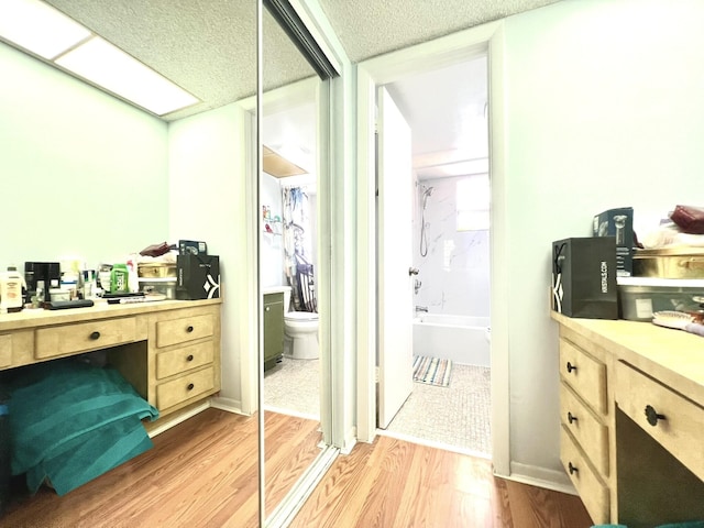 full bathroom with vanity, bathing tub / shower combination, hardwood / wood-style flooring, toilet, and a textured ceiling