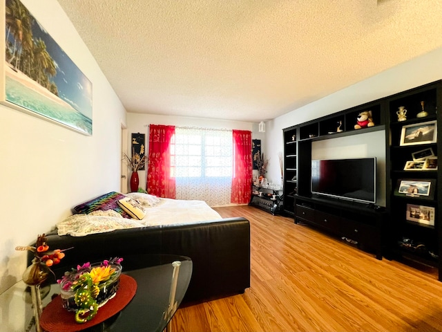 bedroom featuring a textured ceiling and hardwood / wood-style flooring