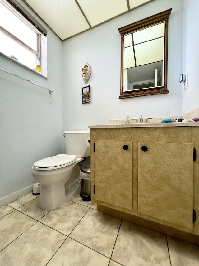 bathroom with tile patterned flooring, vanity, and toilet