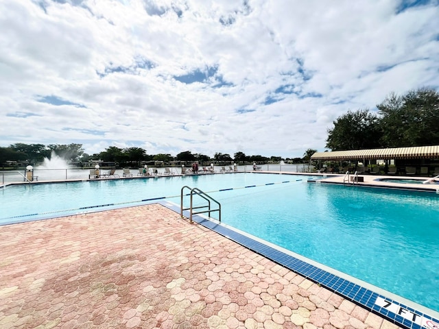 view of pool featuring a patio area and a community hot tub