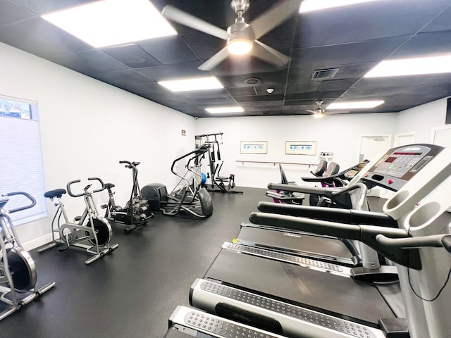 gym featuring a paneled ceiling and ceiling fan