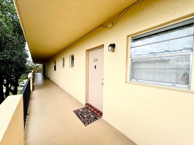 view of exterior entry with a balcony