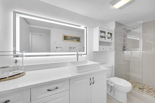 bathroom with tile patterned floors, vanity, an enclosed shower, and toilet