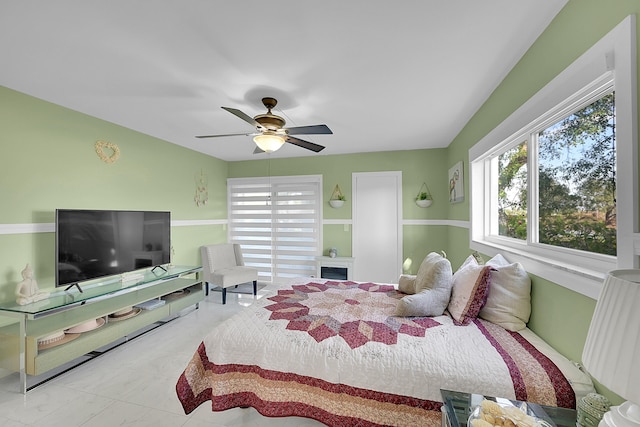 bedroom featuring ceiling fan and radiator