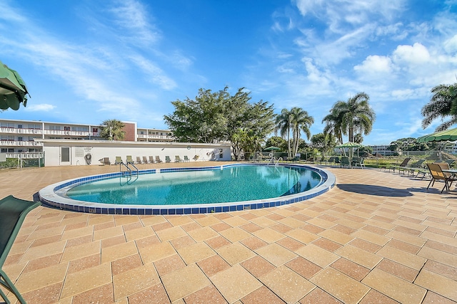 view of swimming pool with a patio