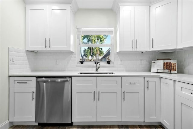 kitchen featuring white cabinetry, dishwasher, sink, and tasteful backsplash