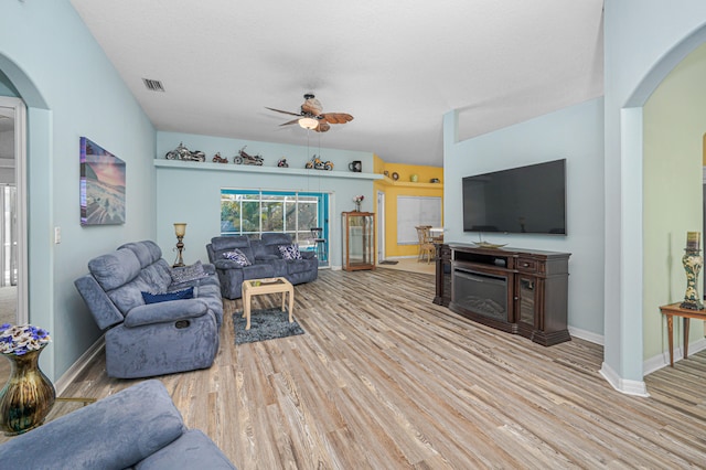 living room with ceiling fan and light wood-type flooring