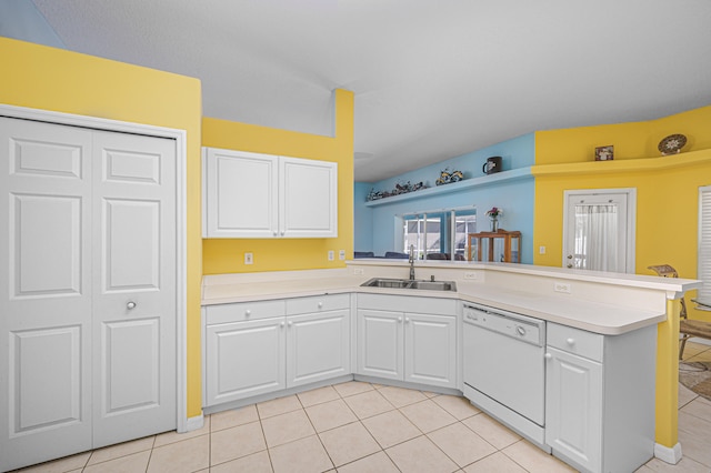 kitchen featuring kitchen peninsula, dishwasher, white cabinets, and sink