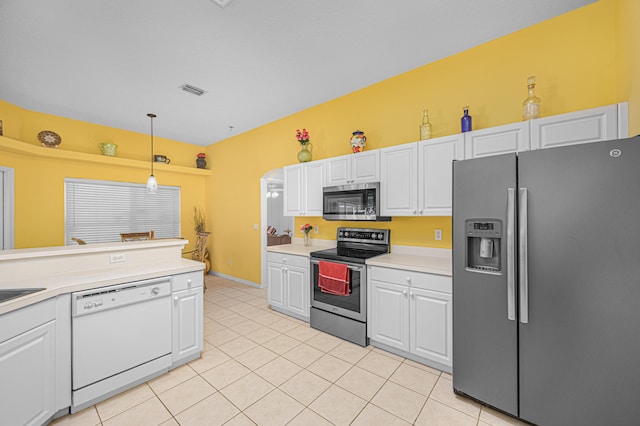 kitchen with white cabinets, pendant lighting, light tile patterned floors, and stainless steel appliances