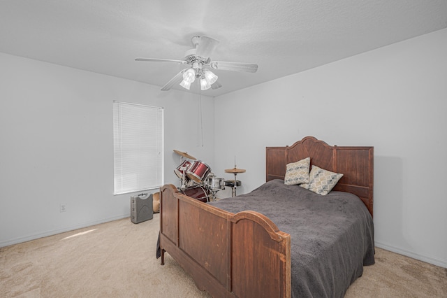 carpeted bedroom with ceiling fan and a textured ceiling