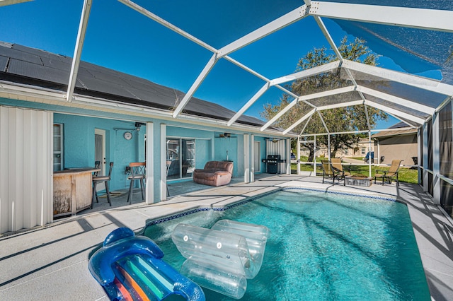 view of pool with a grill and a patio