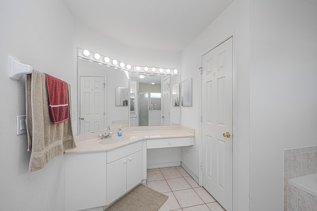 bathroom featuring tile patterned flooring, shower with separate bathtub, and vanity