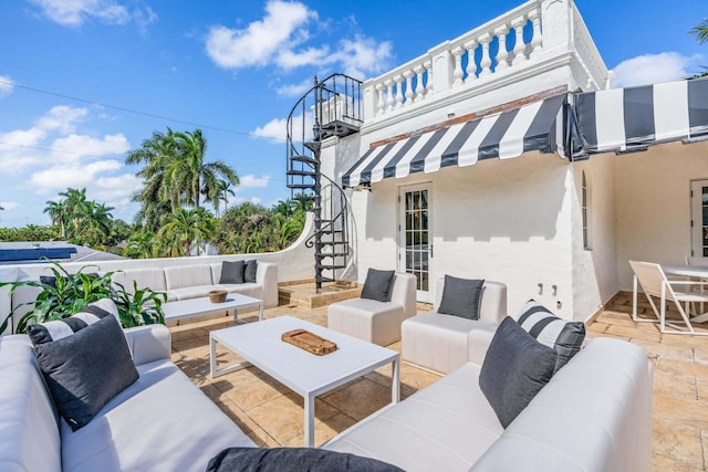 view of patio featuring an outdoor living space and a balcony