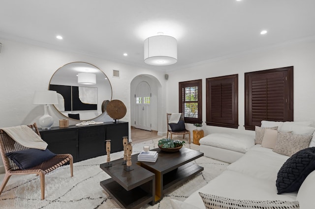 living room featuring crown molding and light wood-type flooring