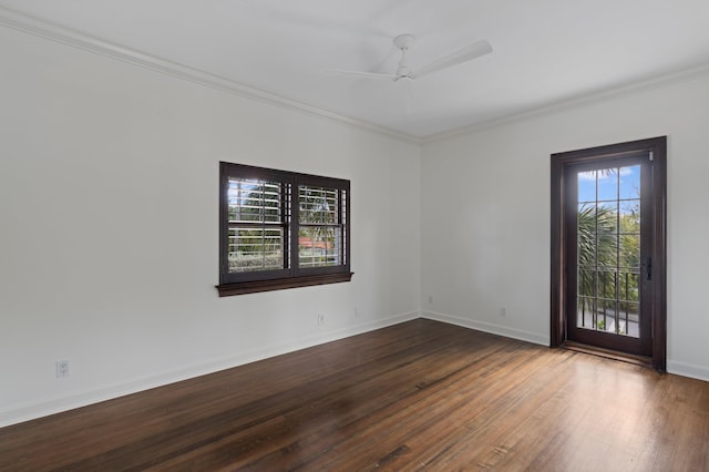 empty room featuring wood-type flooring, a wealth of natural light, and ornamental molding