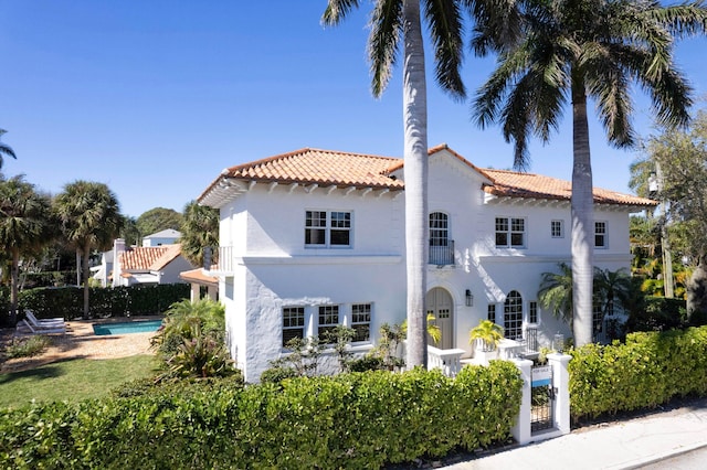 back of property featuring a fenced in pool