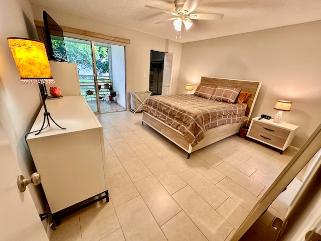 tiled bedroom featuring a textured ceiling, access to outside, and ceiling fan