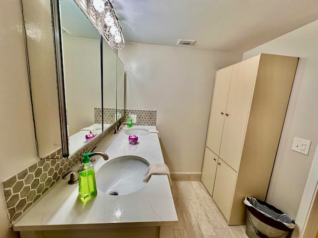 bathroom with wood-type flooring and vanity