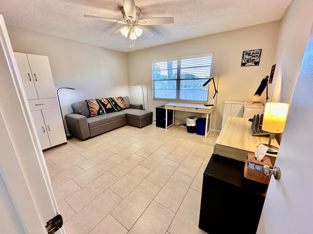 tiled living room with ceiling fan and a textured ceiling