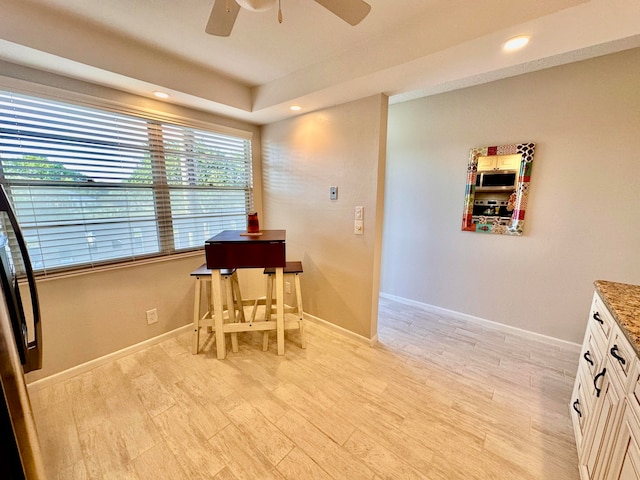 dining space with ceiling fan and light hardwood / wood-style flooring