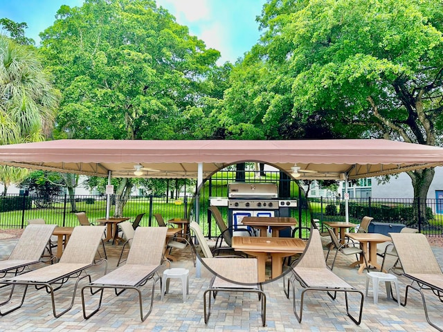 view of patio featuring a gazebo, area for grilling, and ceiling fan