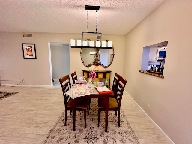 dining room featuring a textured ceiling