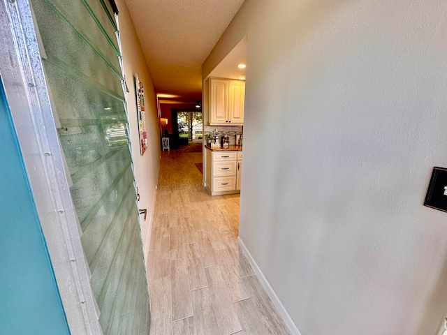 hallway with light wood-type flooring