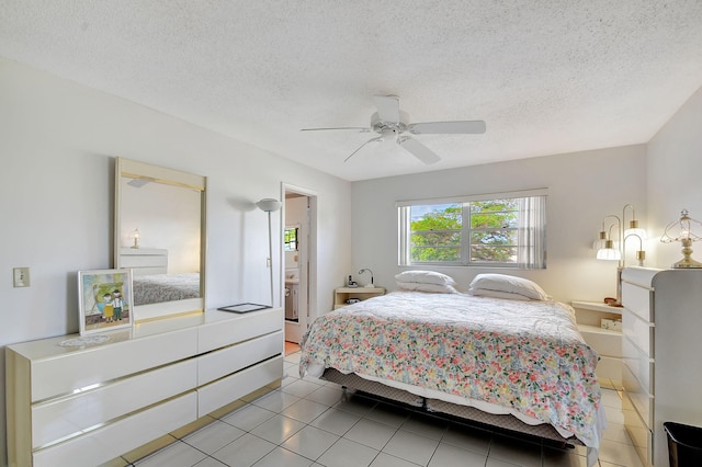 bedroom with tile patterned flooring, a textured ceiling, and ceiling fan