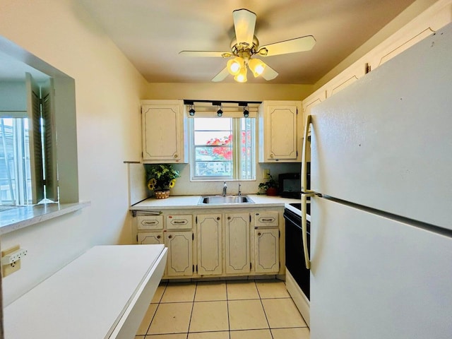 kitchen with ceiling fan, light tile patterned flooring, white appliances, and sink