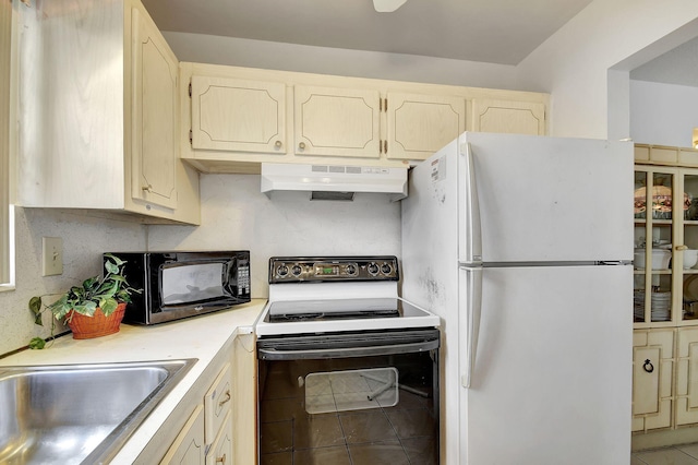 kitchen with decorative backsplash, tile patterned flooring, white appliances, and sink