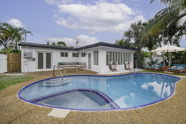 view of pool featuring an outdoor living space, french doors, and a patio